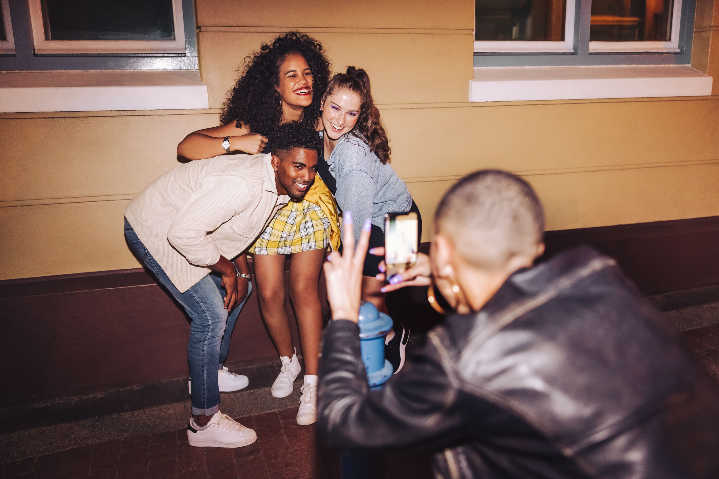 06 Girl Taking Photo of Friends Outside Party