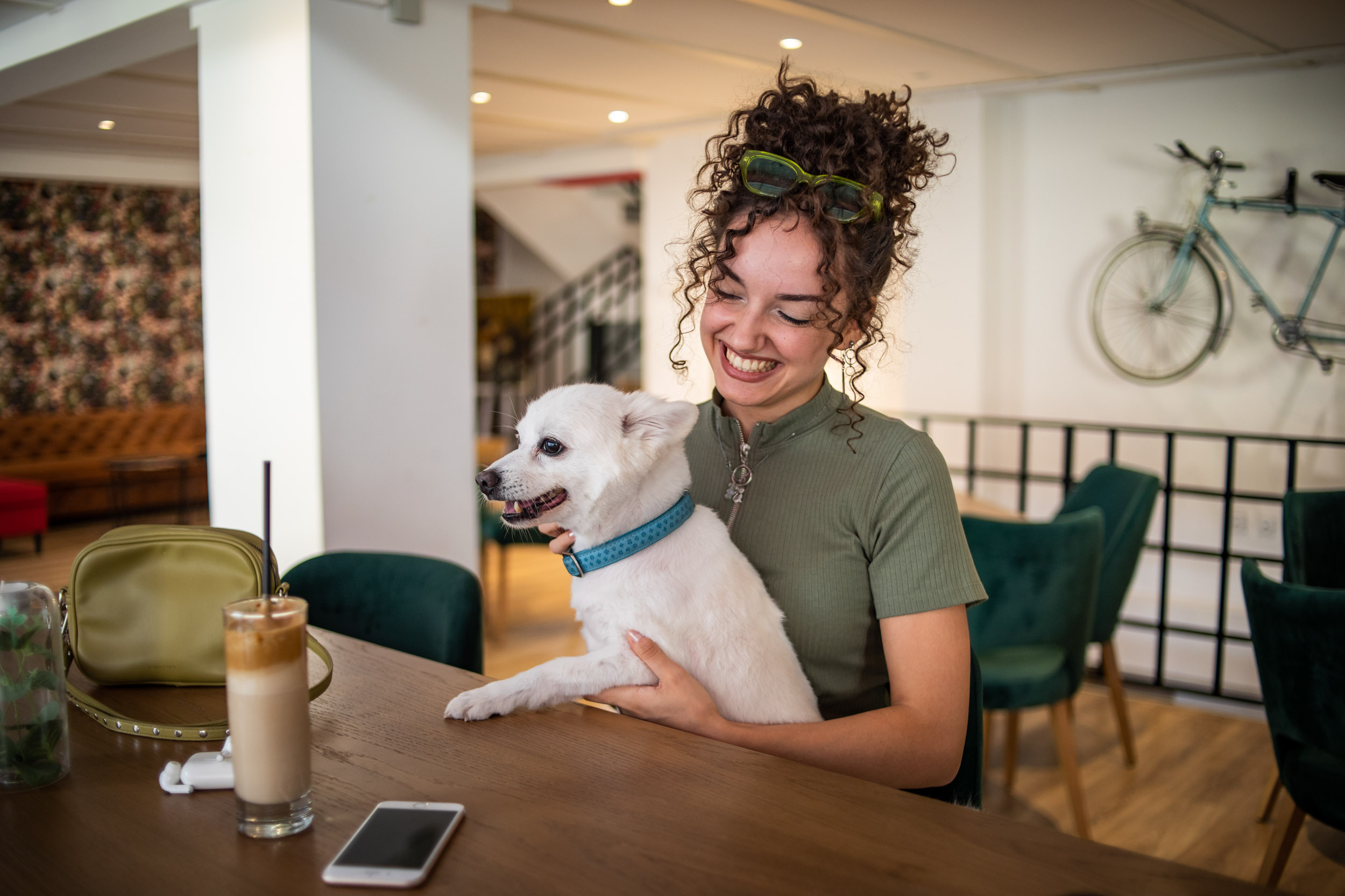 09 Girl Smiling and Holding White Dog on Table